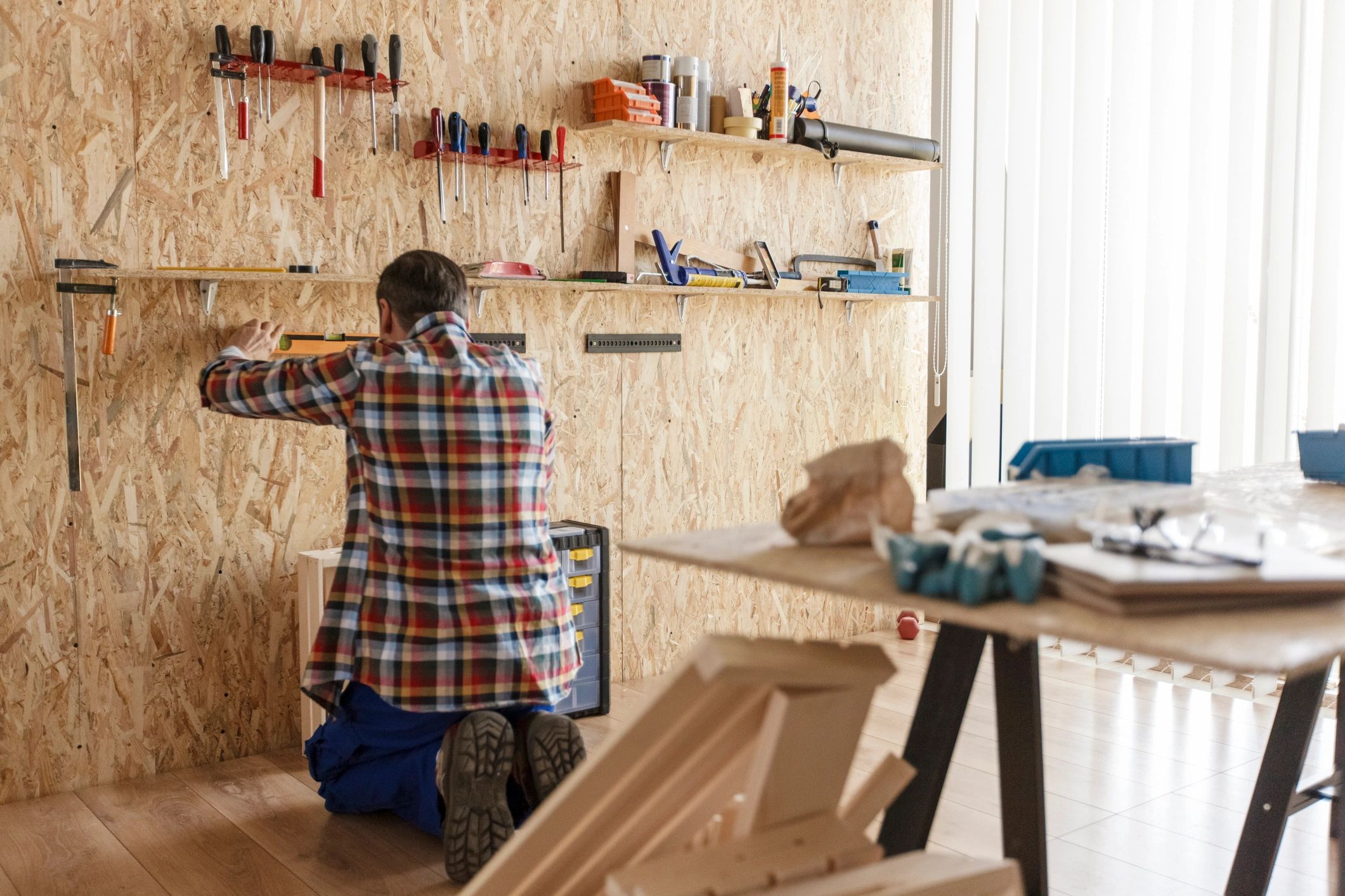 Carpenter using a level to check alignment