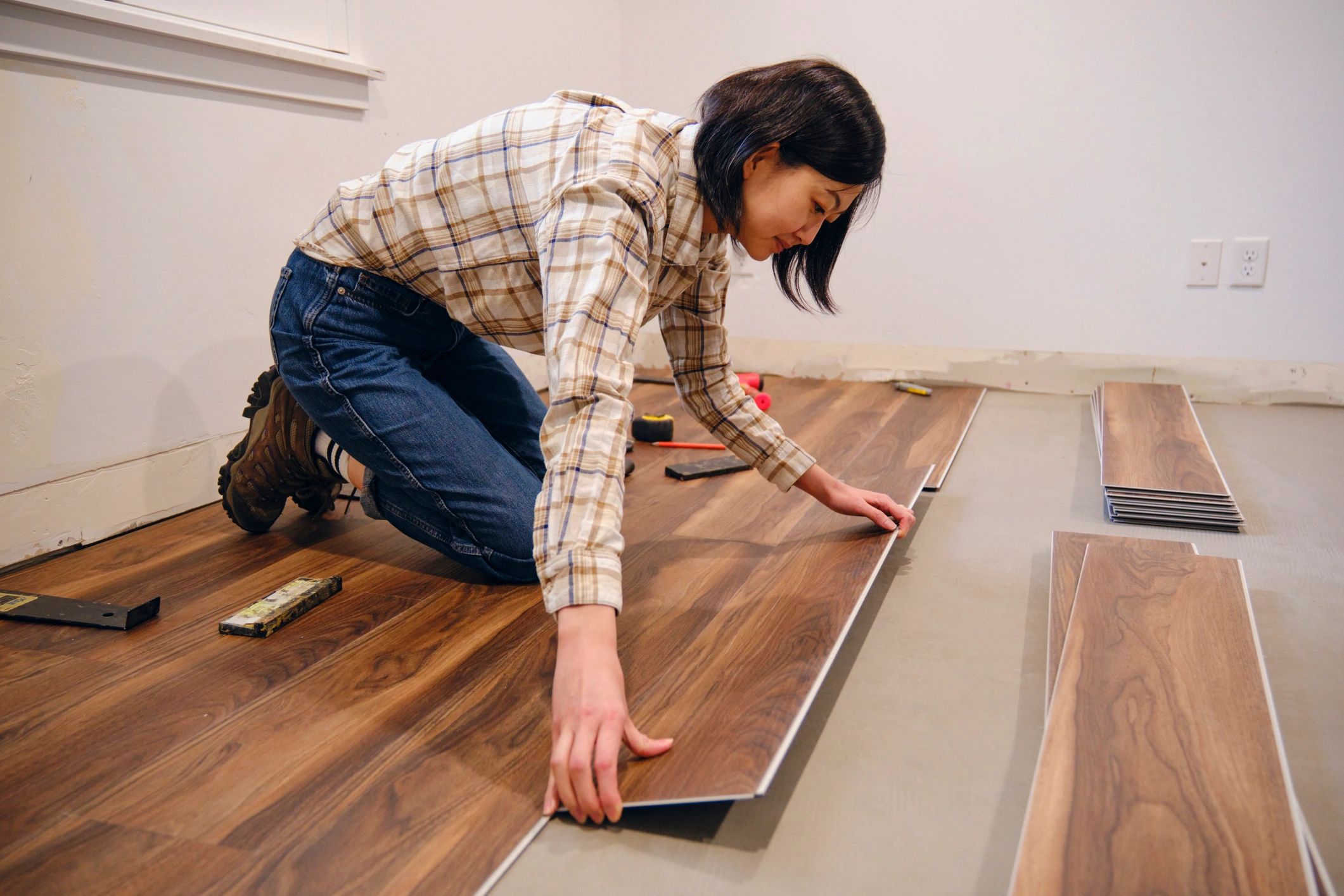 Installer working on laminate flooring