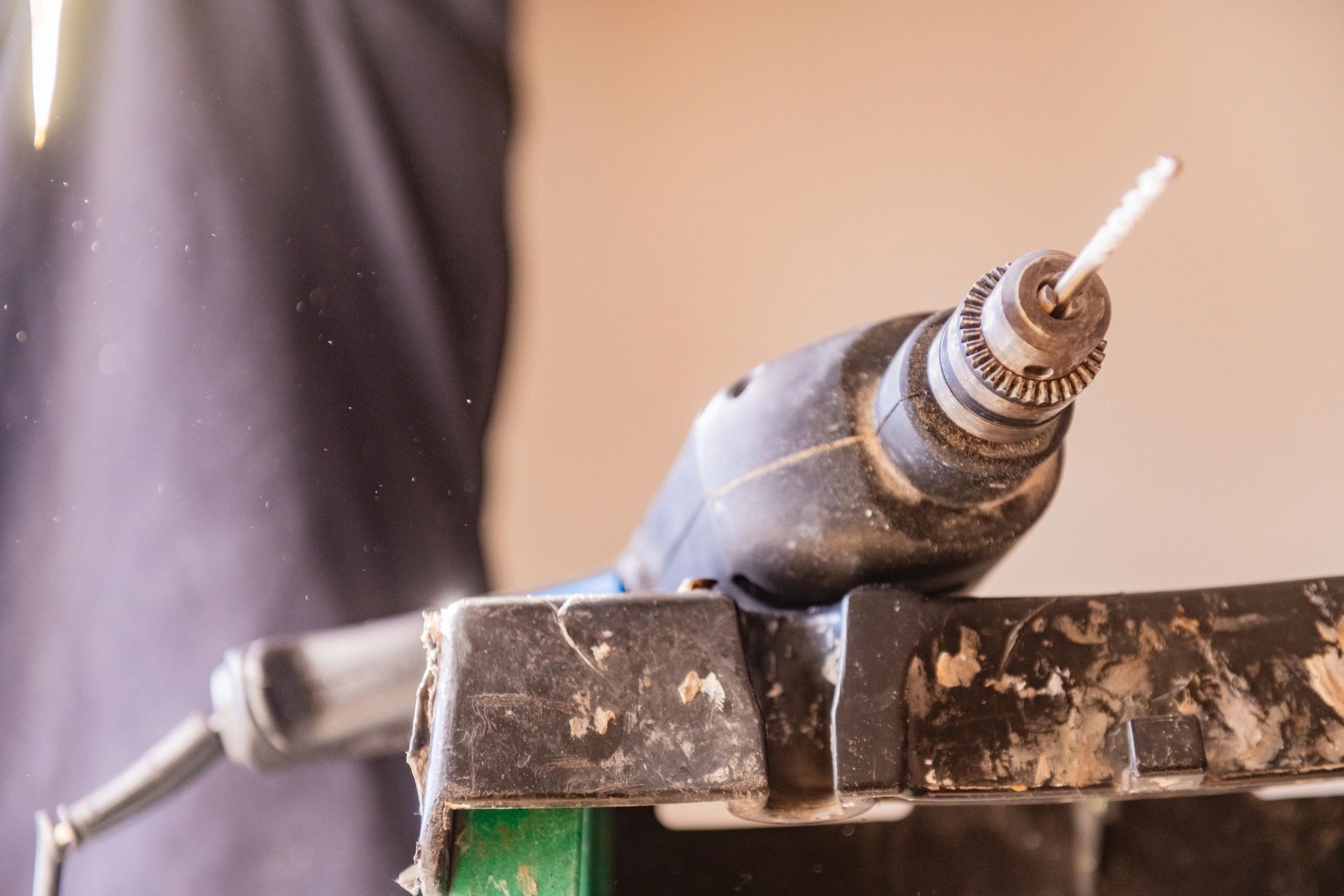 Power drill resting on a ladder during a home improvement project